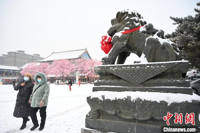 2月13日，民眾在呼和浩特市大召廣場雪中漫步?！⑽娜A 攝