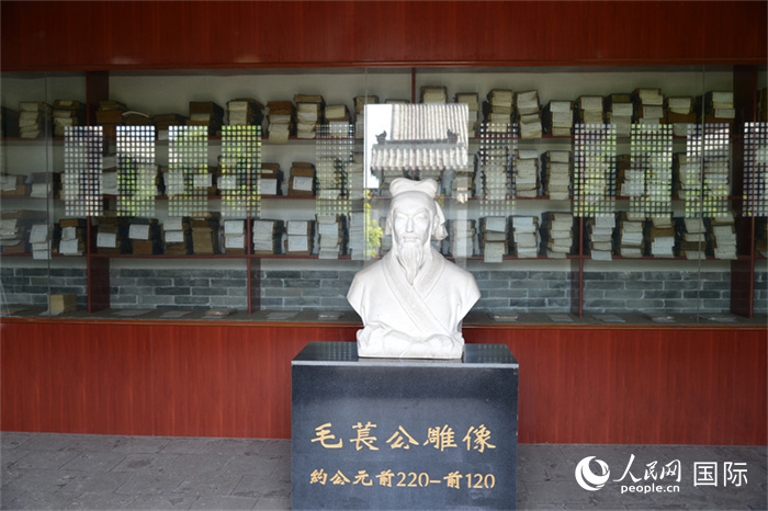 河間詩經(jīng)齋毛萇雕像。雕像后書櫥中陳列的是歷代各版本《詩經(jīng)》及譯本。 人民網(wǎng) 趙昭攝