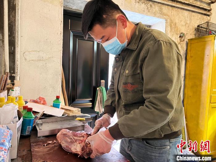 圖為雪豹“奶爸”史壽軍正在準(zhǔn)備投喂雪豹的食材?！●R銘言 攝