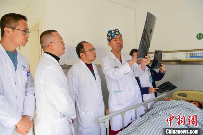 圖為醫(yī)療援藏專家何蔚(站右二)與馮敬云(左二)、廖濤(左三)等人討論患者病情。(資料圖) 貢嘎來松 攝