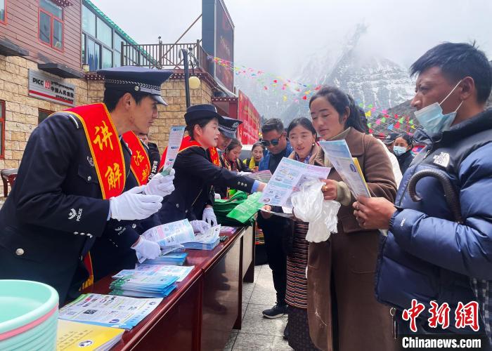 圖為山南玉麥邊境派出所民警為轄區(qū)群眾發(fā)放法律知識(shí)宣傳單。　鐘鑫 　攝